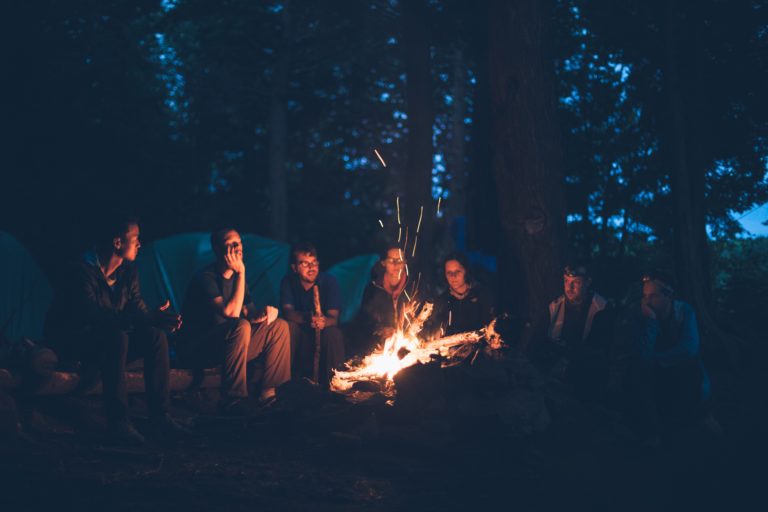 A group sitting around a campfire telling stories