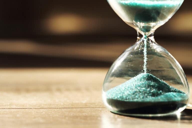 An image of an hourglass representing time passing as an SEO strategy unfolds.