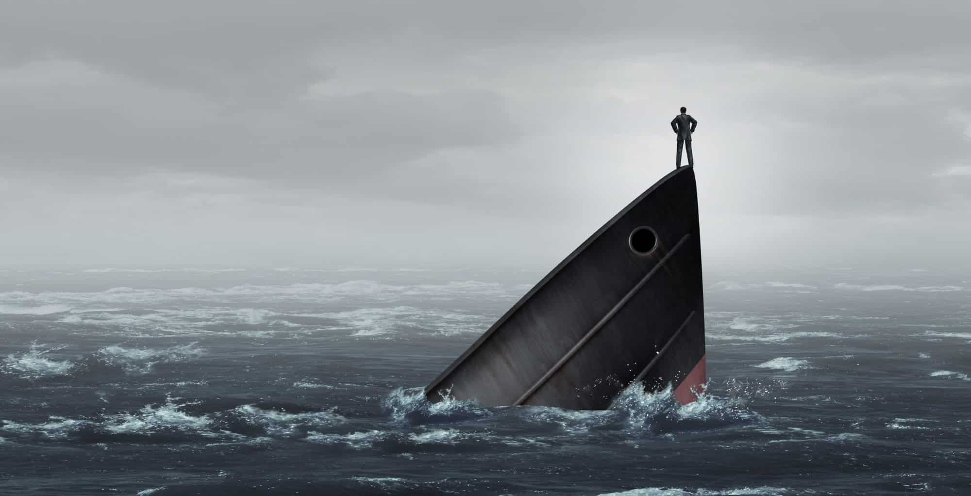 A sinking ship with someone triumphantly standing on its bow.